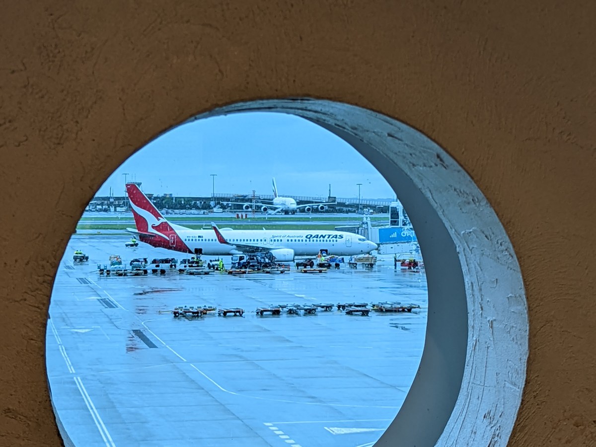 Qantas aircraft seen from an airport terminal window