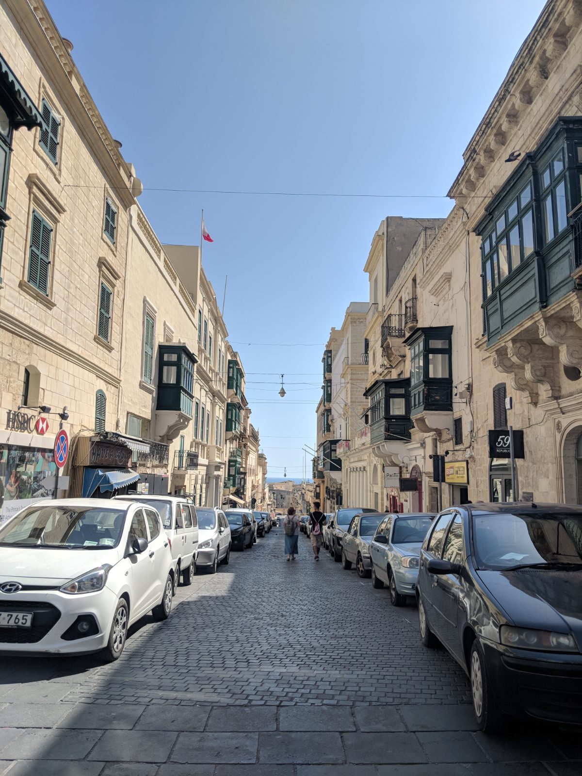 A narrow limestone street in Mġarr, Malta